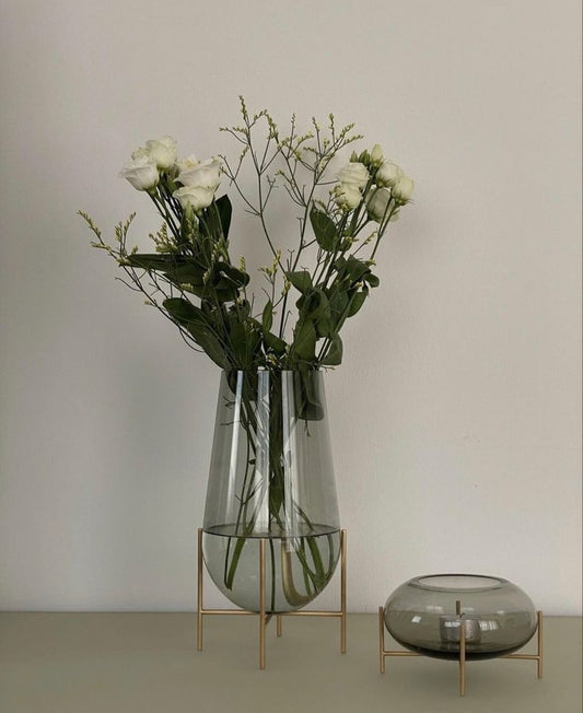 Modern creative dark glass vase with a gold stand